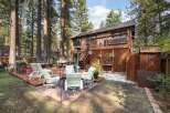 Enjoy outdoor living in this spacious backyard featuring multiple decks and a patio area perfect for entertaining.