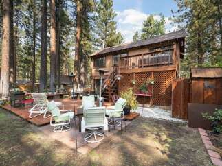 Enjoy outdoor living in this spacious backyard featuring multiple decks and a patio area perfect for entertaining.