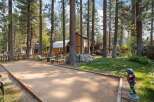 Enjoy outdoor recreation with a dedicated bocce ball court set amidst a serene, wooded landscape.