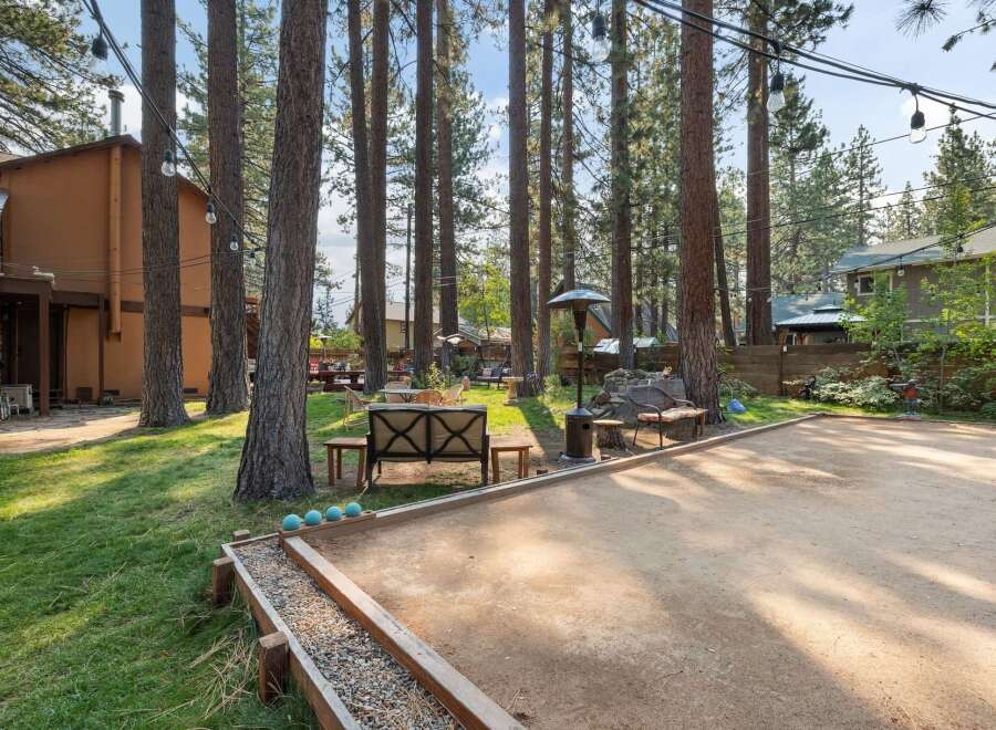 Enjoy outdoor fun in this spacious backyard featuring a bocce ball court perfect for friendly competition.