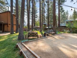 Enjoy outdoor fun in this spacious backyard featuring a bocce ball court perfect for friendly competition.