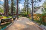Enjoy outdoor fun in this charming backyard featuring a bocce ball court perfect for friendly competition.