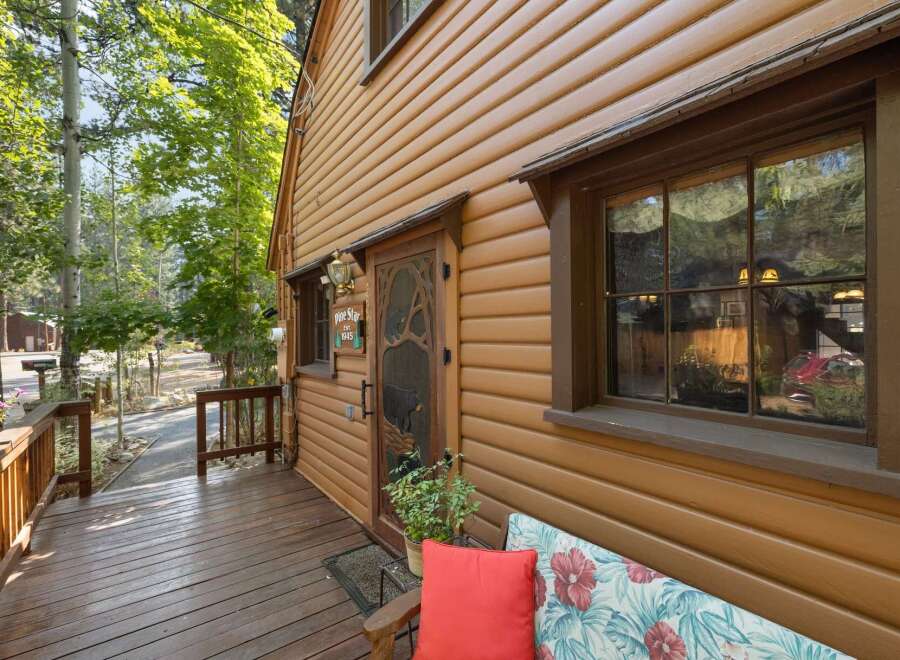 Charming log cabin nestled amongst tall trees, offering a rustic retreat.