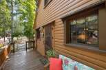 Charming log cabin nestled amongst tall trees, offering a rustic retreat.