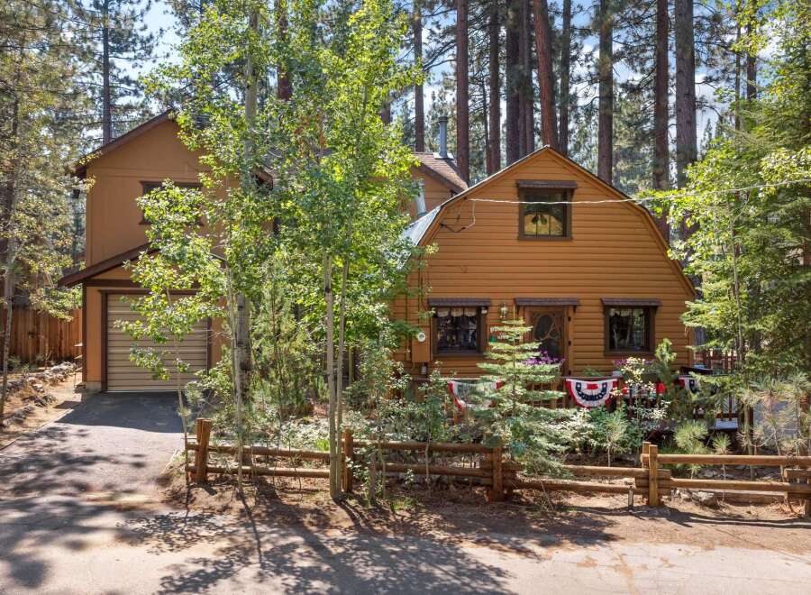 Nestled among tall pine trees, this charming cabin offers a serene mountain retreat.