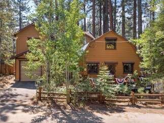 Nestled among tall pine trees, this charming cabin offers a serene mountain retreat.