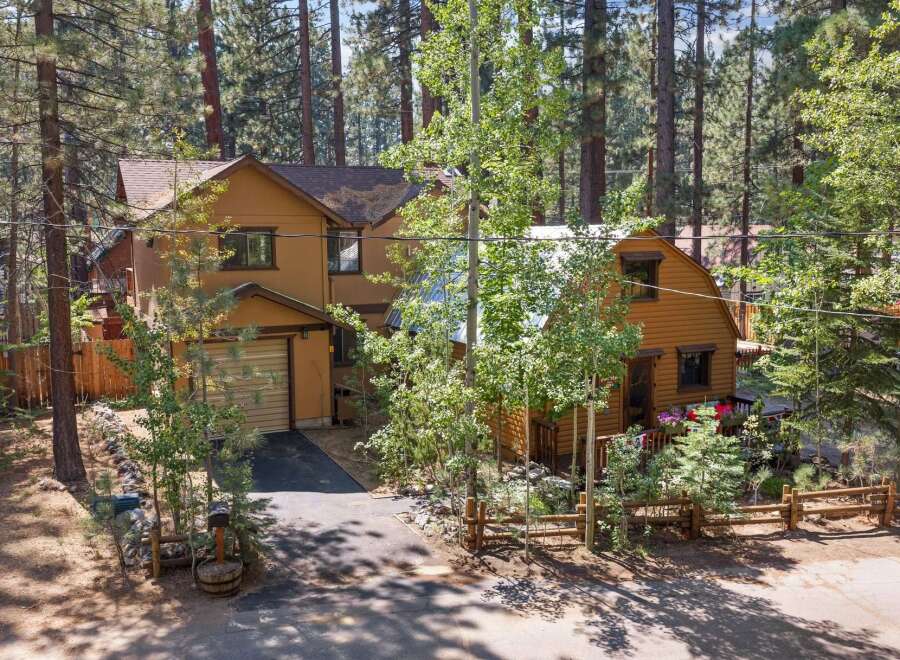 Nestled amongst tall pine trees, this charming mountain home offers a serene escape.