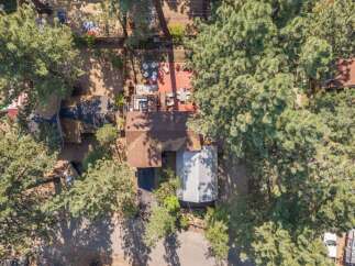 Discover this charming property featuring a spacious wooden deck perfect for outdoor entertaining, complete with comfortable seating and a dining area.
