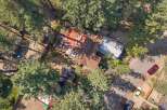 Discover this charming property featuring a spacious deck perfect for outdoor entertaining, surrounded by mature trees offering privacy and shade.