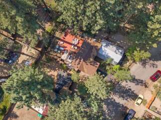 Discover this charming property featuring a spacious deck perfect for outdoor entertaining, surrounded by mature trees offering privacy and shade.