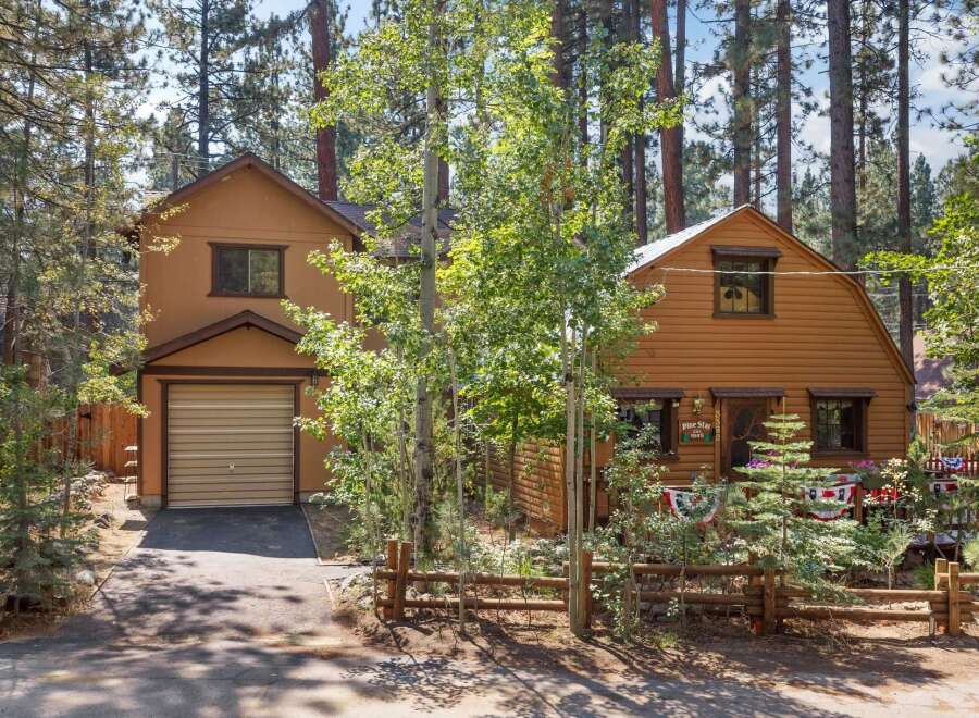 Nestled among tall pine trees, this charming cabin offers a serene mountain getaway.