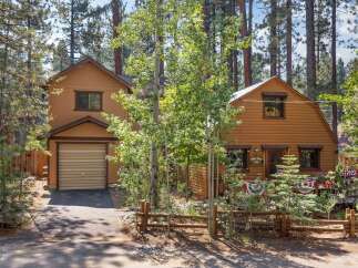 Nestled among tall pine trees, this charming cabin offers a serene mountain getaway.