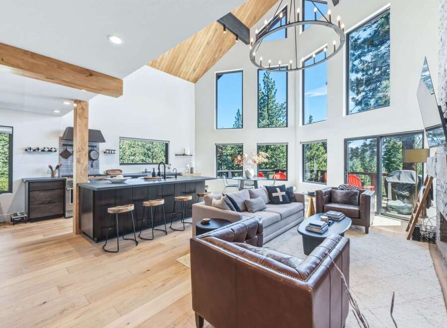 Experience modern mountain living in this stunning open-concept home, featuring a gourmet kitchen with a large island and sleek cabinetry.
