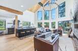 Experience modern mountain living in this stunning open-concept home, featuring a gourmet kitchen with a large island and sleek cabinetry.