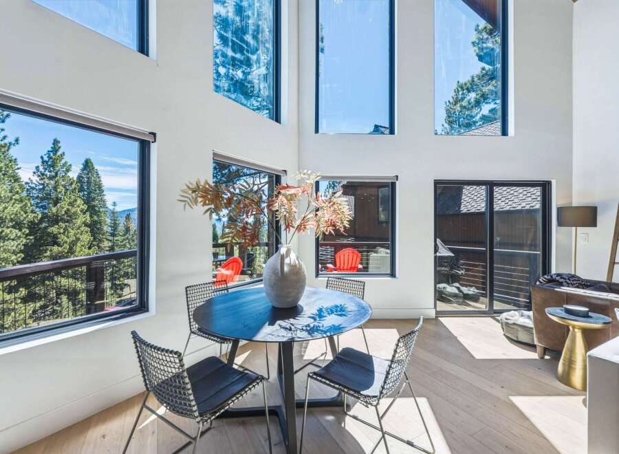 Experience breathtaking mountain views from this stunning modern home, featuring expansive floor-to-ceiling windows that flood the living space with natural light.