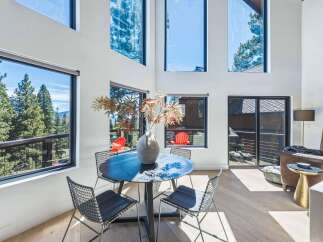 Experience breathtaking mountain views from this stunning modern home, featuring expansive floor-to-ceiling windows that flood the living space with natural light.