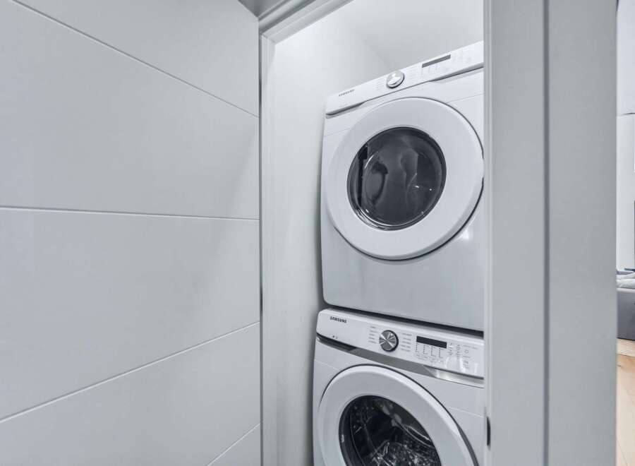 Discover modern convenience with this stacked Samsung washer and dryer set, perfect for maximizing space in your laundry area.