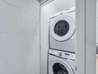 Discover modern convenience with this stacked Samsung washer and dryer set, perfect for maximizing space in your laundry area.