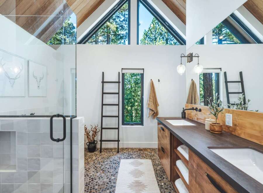 Experience luxury in this stunning modern bathroom, featuring a spacious walk-in shower with elegant tile work and a sleek glass enclosure.