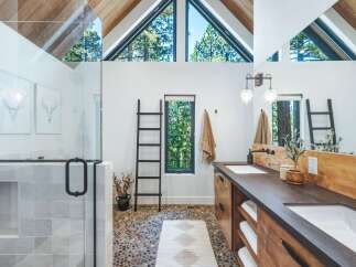 Experience luxury in this stunning modern bathroom, featuring a spacious walk-in shower with elegant tile work and a sleek glass enclosure.