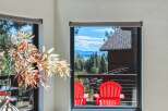Enjoy breathtaking mountain and lake views from this stunning property, framed by a large window.