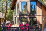 Experience mountain living in this charming cabin featuring a spacious deck with a grill and seating, perfect for outdoor entertaining.