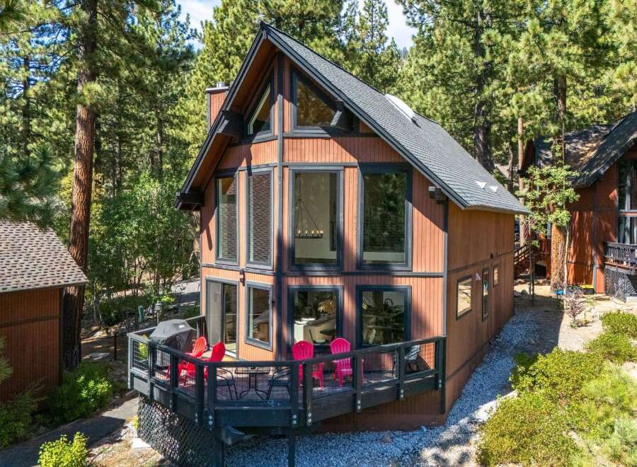 Experience mountain living in this charming A-frame cabin nestled among tall pine trees.