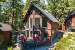 Experience mountain living in this charming A-frame cabin nestled among tall pine trees.