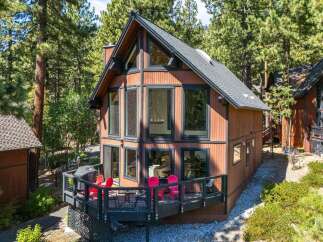 Experience mountain living in this charming A-frame cabin nestled among tall pine trees.