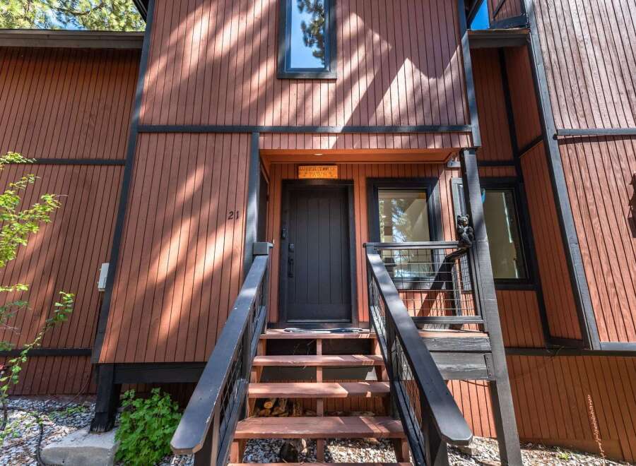 Charming A-frame home with rustic wood siding and a welcoming entrance.