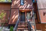 Charming A-frame home with rustic wood siding and a welcoming entrance.