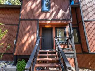 Charming A-frame home with rustic wood siding and a welcoming entrance.