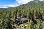 Nestled amidst a lush pine forest, this charming cabin offers a serene mountain retreat.