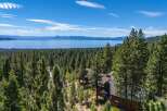 Experience breathtaking panoramic views of Lake Tahoe from this stunning property nestled amidst a dense pine forest.