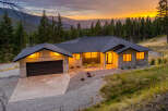 Experience luxury mountain living in this stunning modern home, nestled amidst a breathtaking landscape.