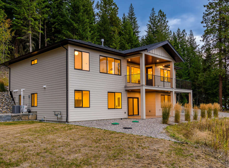 Experience modern living in this stunning two-story home nestled amongst lush evergreen trees.