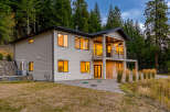Experience modern living in this stunning two-story home nestled amongst lush evergreen trees.