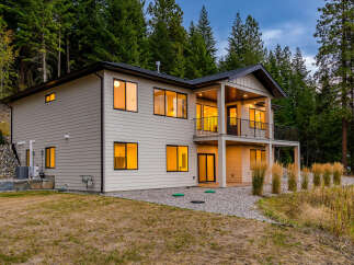 Experience modern living in this stunning two-story home nestled amongst lush evergreen trees.