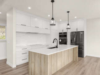 Experience modern luxury in this stunning kitchen, featuring sleek white cabinetry, a striking marble backsplash, and a spacious island with a natural wood finish.