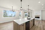 Experience modern living in this stunning open-concept kitchen and living area, featuring a sleek island with a double sink and a beautiful quartz countertop.