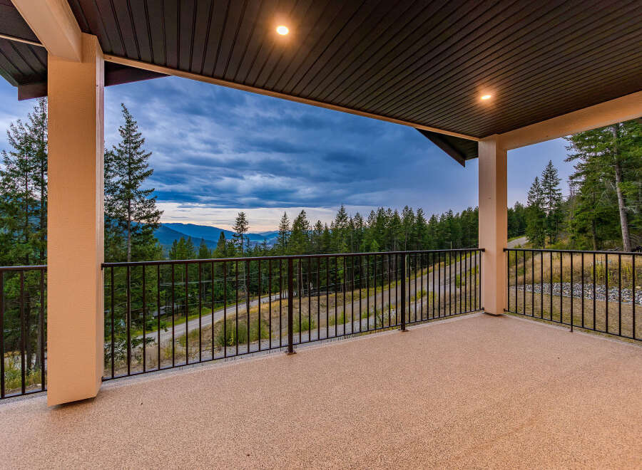 Enjoy breathtaking panoramic views from this expansive covered deck, perfect for entertaining or quiet relaxation.