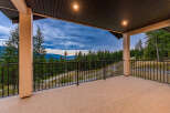 Enjoy breathtaking panoramic views from this expansive covered deck, perfect for entertaining or quiet relaxation.