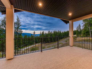 Enjoy breathtaking panoramic views from this expansive covered deck, perfect for entertaining or quiet relaxation.