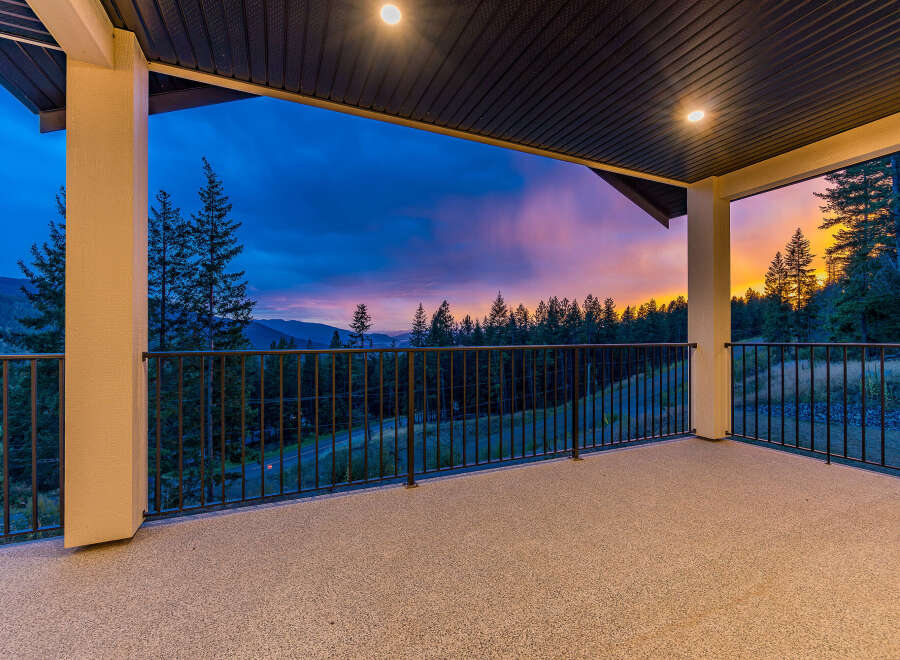 Experience breathtaking sunset views from this expansive covered balcony, perfect for enjoying the serene mountain landscape.