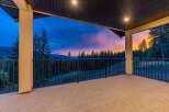 Experience breathtaking sunset views from this expansive covered balcony, perfect for enjoying the serene mountain landscape.