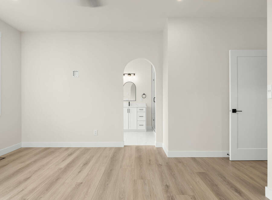 Step into this beautifully renovated space featuring a modern open-concept layout with sleek, light-wood flooring.