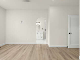 Step into this beautifully renovated space featuring a modern open-concept layout with sleek, light-wood flooring.