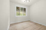 This bright and airy room features a large window offering scenic views of the surrounding greenery.