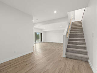 Discover this spacious and bright basement with a modern aesthetic, featuring elegant wood-look flooring and a neutral color palette.