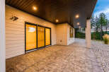 Experience seamless indoor-outdoor living with this stunning covered patio, featuring elegant stamped concrete flooring and recessed lighting for evening ambiance.